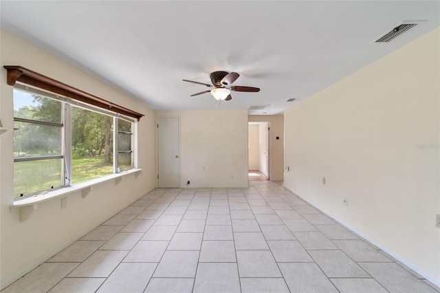 tiled empty room with ceiling fan