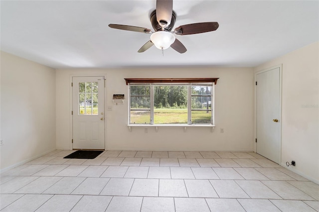 entrance foyer with ceiling fan and light tile patterned floors