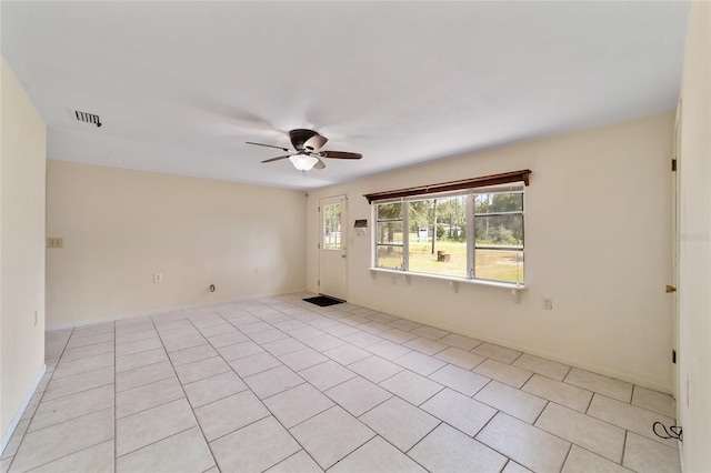 unfurnished room with light tile patterned floors and ceiling fan