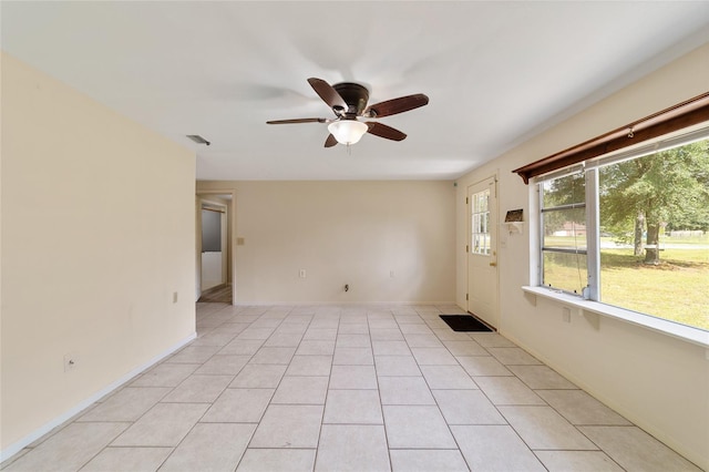 tiled spare room with ceiling fan