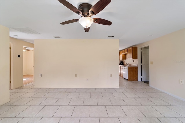 spare room with ceiling fan and light tile patterned floors