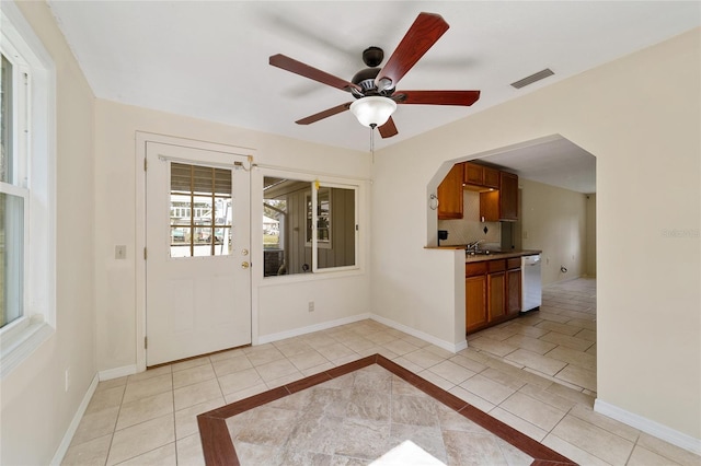 tiled foyer entrance featuring sink and ceiling fan