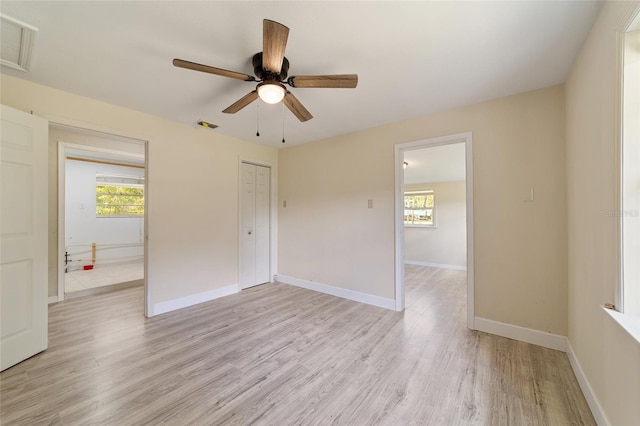 spare room featuring ceiling fan, light hardwood / wood-style flooring, and plenty of natural light