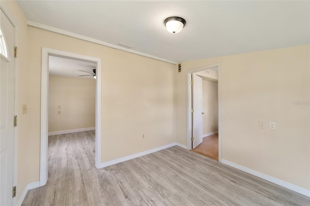 unfurnished room with ceiling fan and light wood-type flooring