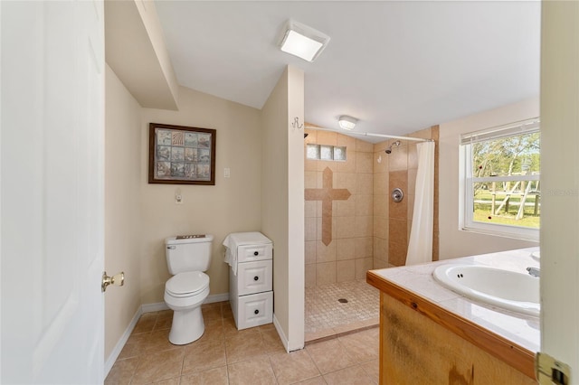 bathroom featuring curtained shower, tile patterned flooring, vanity, and toilet