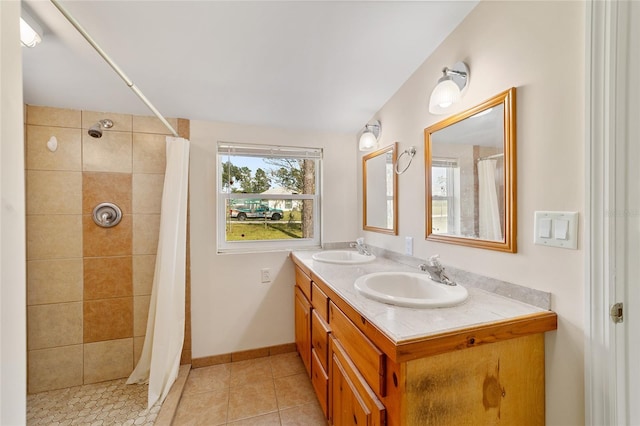 bathroom with lofted ceiling, vanity, curtained shower, and tile patterned floors