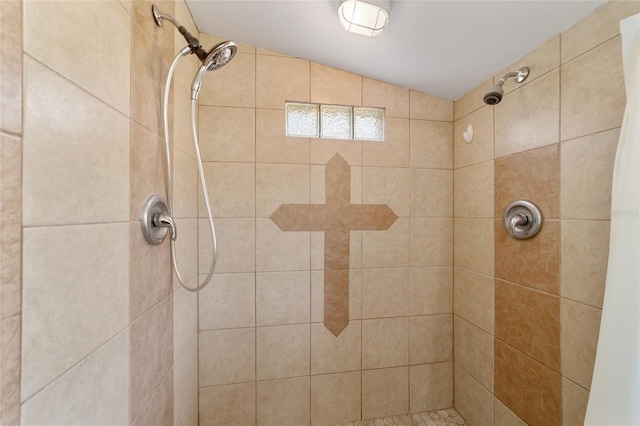 bathroom with walk in shower and lofted ceiling