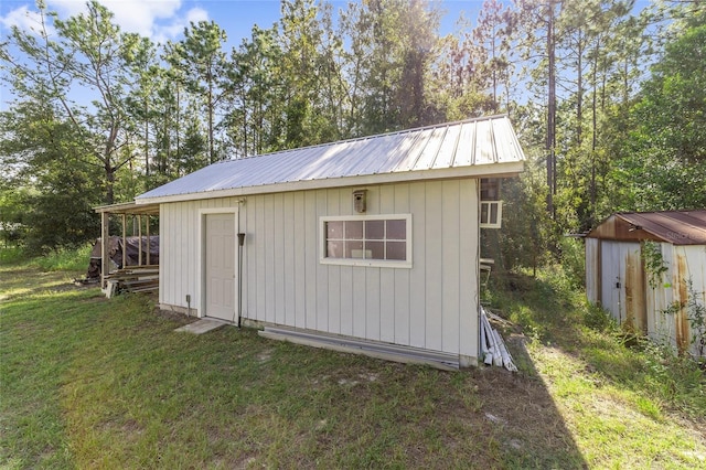 view of outbuilding with a lawn