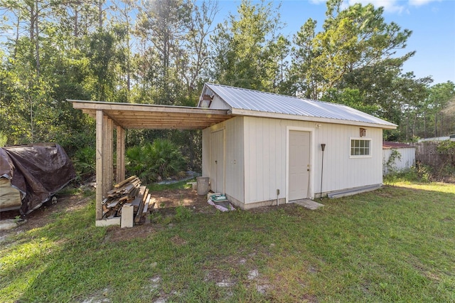 view of outdoor structure featuring a lawn and a carport