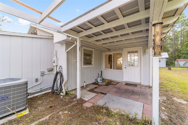 property entrance with central AC unit and a patio area