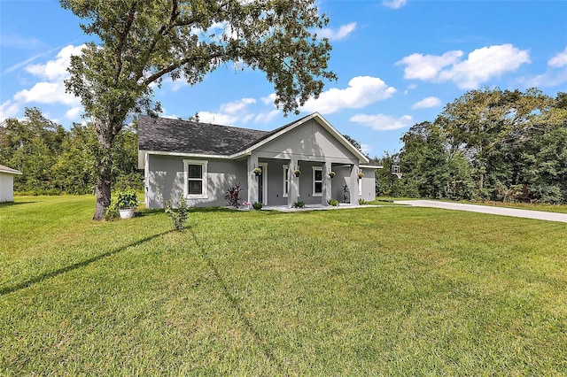 view of front of house featuring covered porch and a front lawn