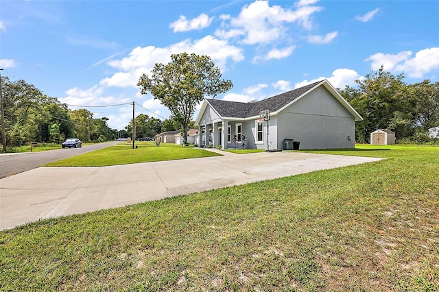 view of side of home with a yard and a storage unit