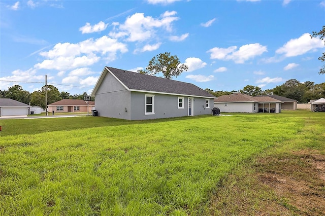 rear view of property with a lawn