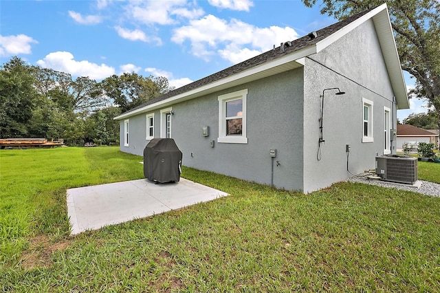 back of property with a patio area, a yard, and cooling unit