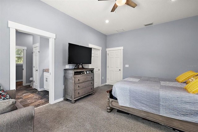 bedroom featuring dark hardwood / wood-style flooring, ceiling fan, and ensuite bathroom