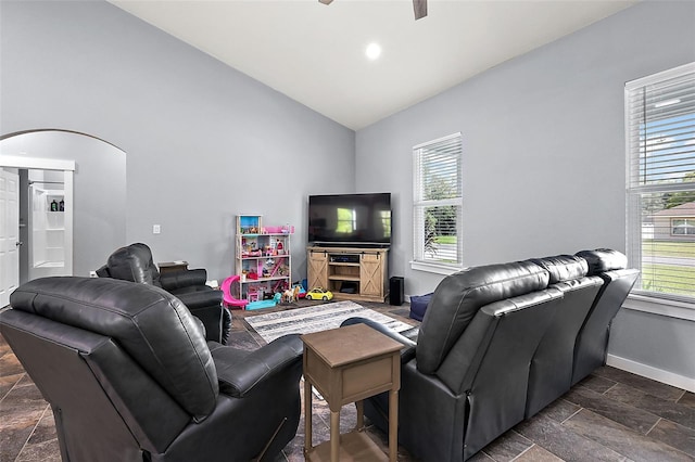 living room featuring a wealth of natural light, ceiling fan, and lofted ceiling