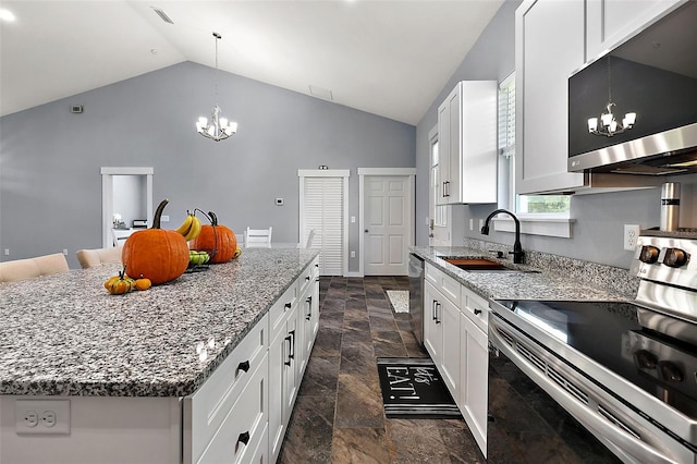 kitchen with white cabinets, stainless steel appliances, sink, and a kitchen island