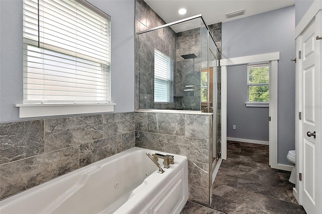 bathroom featuring separate shower and tub and toilet