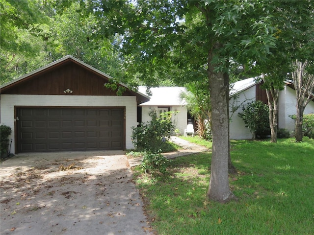 ranch-style home with a garage and a front lawn