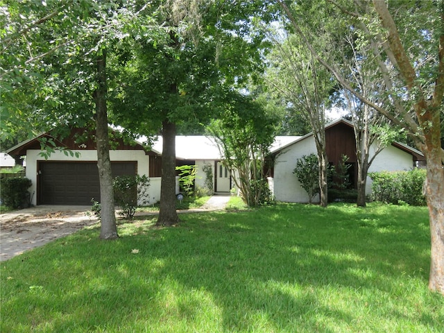 view of front of home with a garage and a front yard