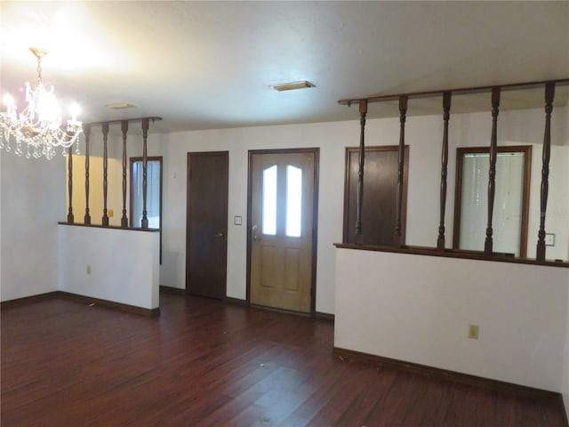 foyer entrance featuring a chandelier and dark hardwood / wood-style flooring