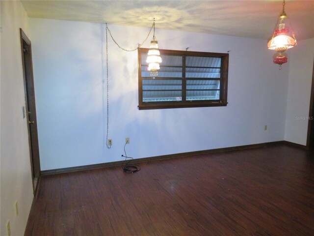 spare room featuring dark hardwood / wood-style flooring