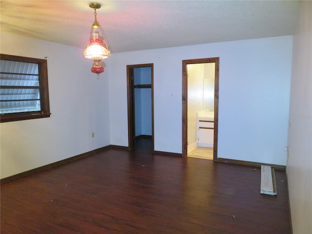 spare room with dark wood-type flooring