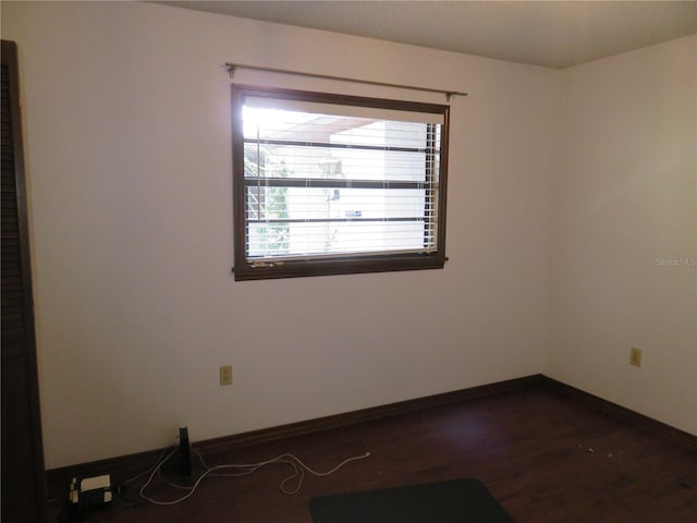 empty room featuring dark wood-type flooring