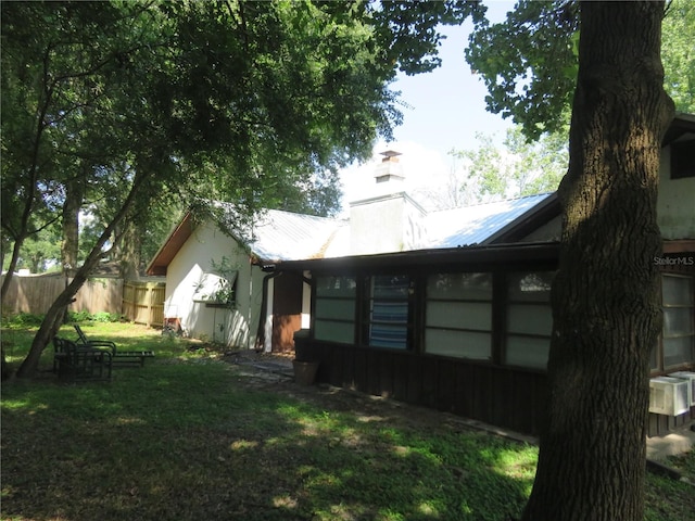 view of side of home with a yard