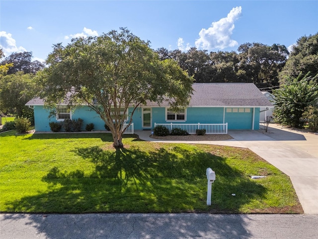 view of front of house featuring a front yard and a garage