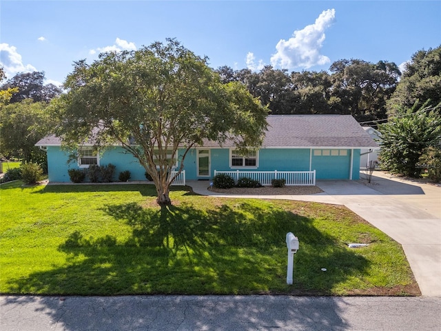 6212 NE 26th Ave, Ocala, FL 34479 - view of front of home featuring concrete driveway, a front lawn, an attached garage, and stucco siding
