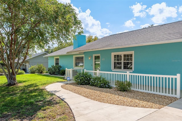 6212 NE 26th Ave, Ocala, FL 34479 - view of front of house featuring a front yard, a chimney, a shingled roof, stucco siding, and a porch