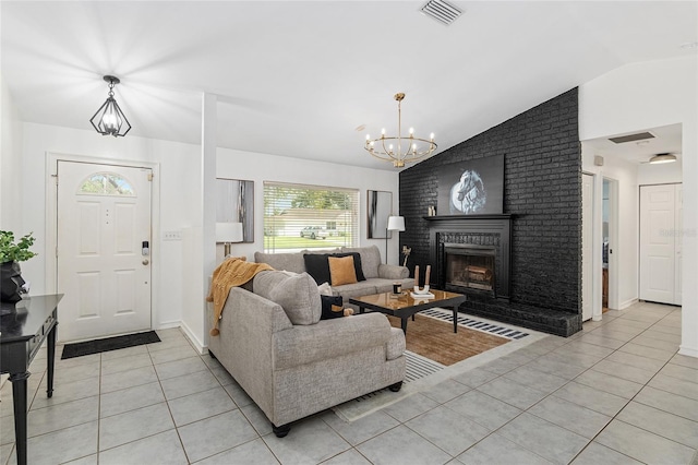 living room featuring a brick fireplace, a notable chandelier, lofted ceiling, and light tile patterned floors