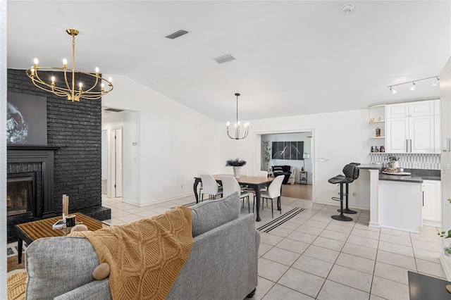 tiled living room featuring lofted ceiling and a fireplace