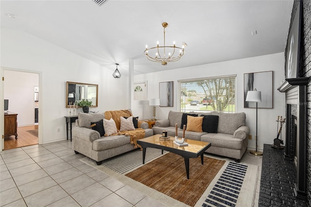 living room with lofted ceiling, light hardwood / wood-style floors, and a chandelier