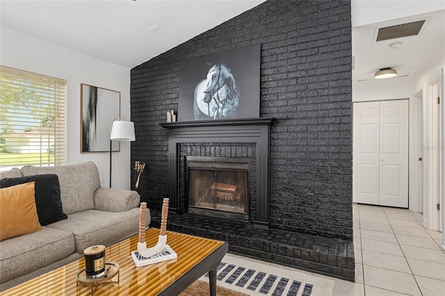 tiled living room with lofted ceiling and a fireplace