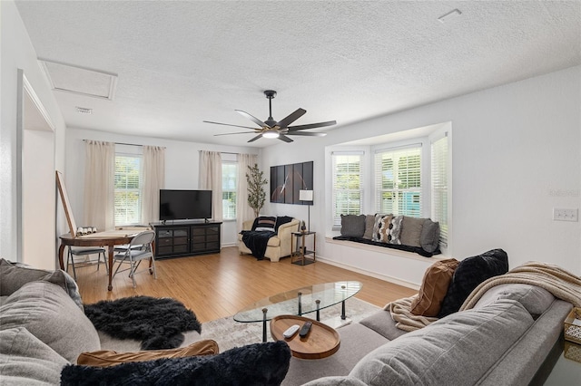6212 NE 26th Ave, Ocala, FL 34479 - living room featuring light wood finished floors, attic access, a textured ceiling, and a ceiling fan