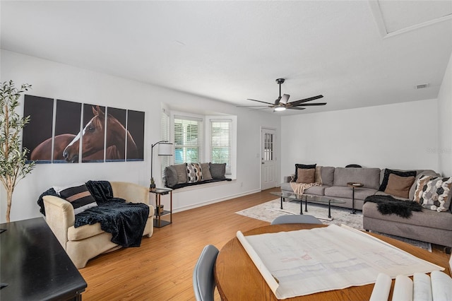 living room with ceiling fan and wood-type flooring