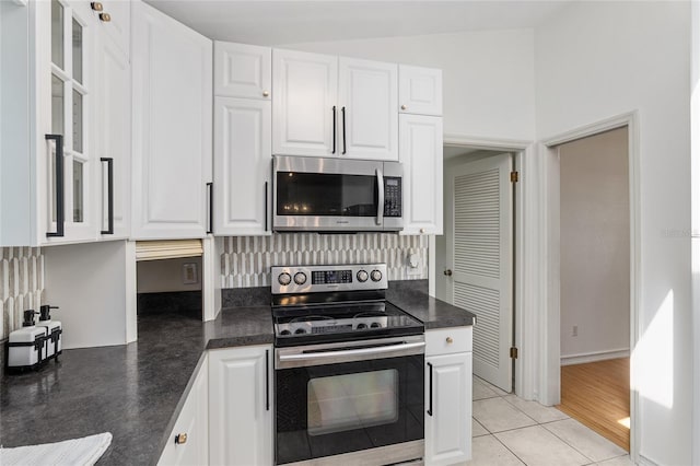 6212 NE 26th Ave, Ocala, FL 34479 - kitchen with appliances with stainless steel finishes, dark countertops, and white cabinetry