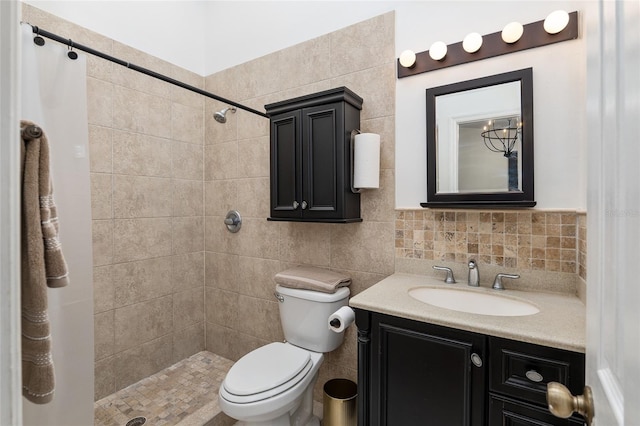 bathroom with walk in shower, vanity, tile walls, and toilet