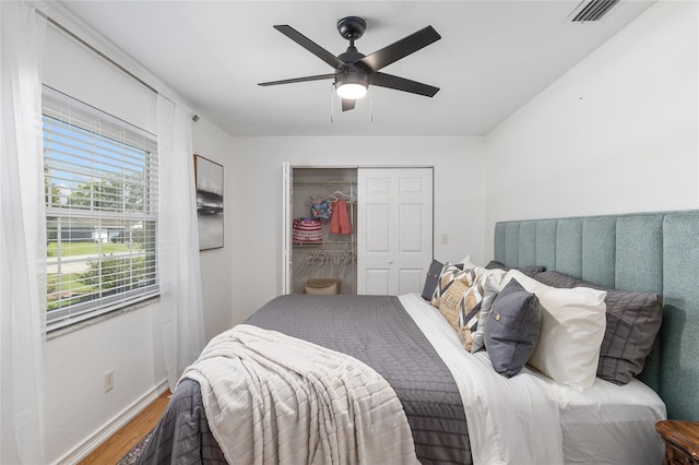 bedroom featuring a closet, hardwood / wood-style flooring, and ceiling fan