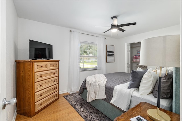 bedroom featuring a closet, light hardwood / wood-style floors, and ceiling fan