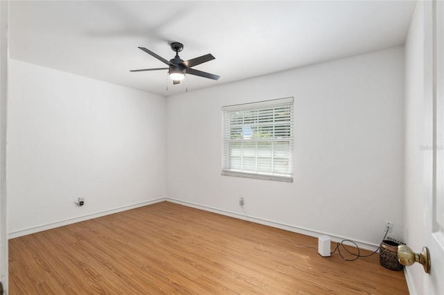 empty room with light hardwood / wood-style flooring and ceiling fan