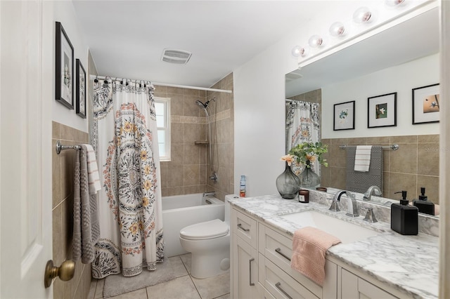 6212 NE 26th Ave, Ocala, FL 34479 - full bath with tile walls, tile patterned flooring, toilet, vanity, and shower / tub combo with curtain