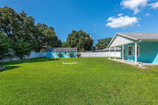 view of yard featuring a shed and a patio