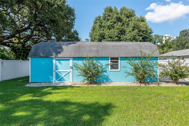 view of outbuilding with a lawn