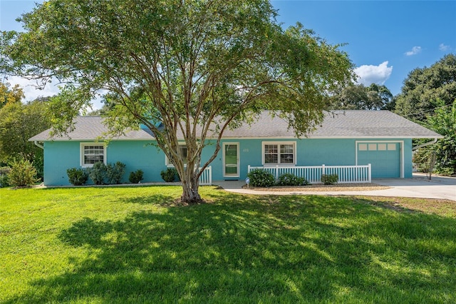 ranch-style home with a front yard and a garage