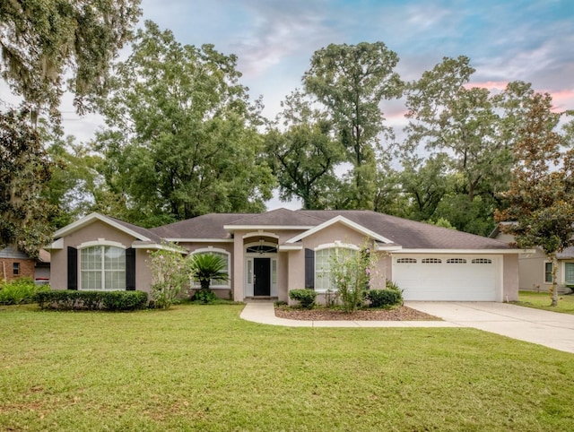 ranch-style house with a lawn and a garage