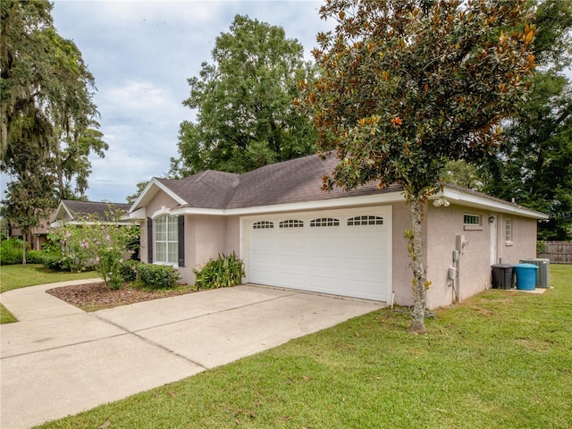 ranch-style home with cooling unit, a front yard, and a garage