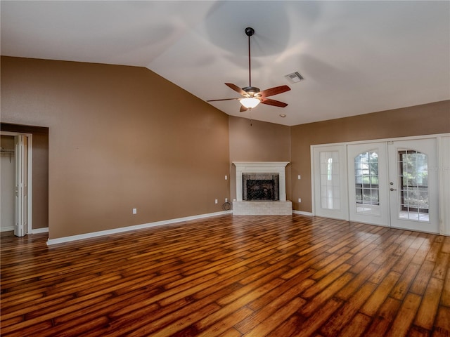 unfurnished living room with ceiling fan, hardwood / wood-style flooring, a fireplace, and vaulted ceiling